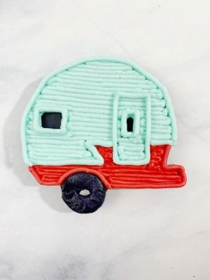 outline the outer edge of the teal portion of the camper. You don't need to re-outline the bottom of the door since that is already done