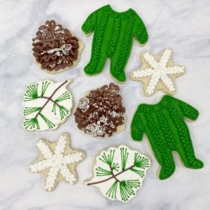 winter baby shower cookies buttercream pine cone cookies and cable knit footie onesies