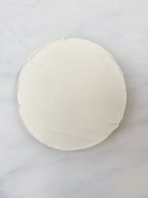 white buttercream smoothed on cookie using palette knife