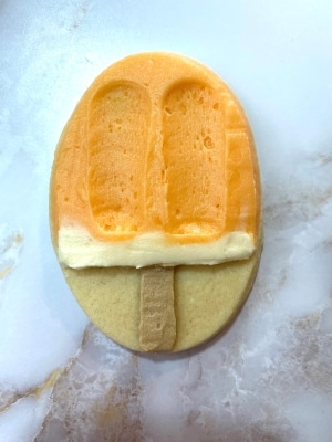 orange flavored buttercream on creamsicle cookie, cleaned up with palette knife