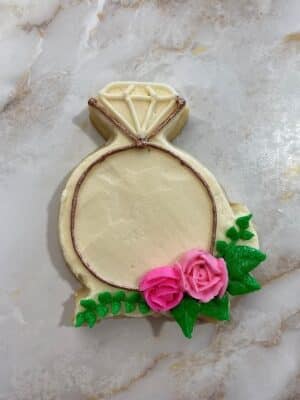 adding small leaves to the engagement ring sugar cookies for bridal shower cookies