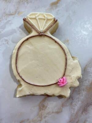 piping a rose bud onto the cookie