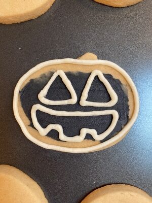 Halloween snake sugar cookies with buttercream outline jack o lantern face