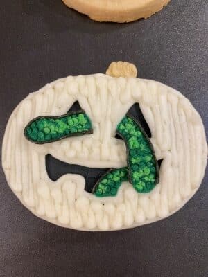Halloween snake sugar cookies with buttercream adding body outline