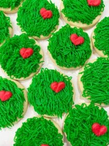 green grinch sugar cookies with buttercream hearts