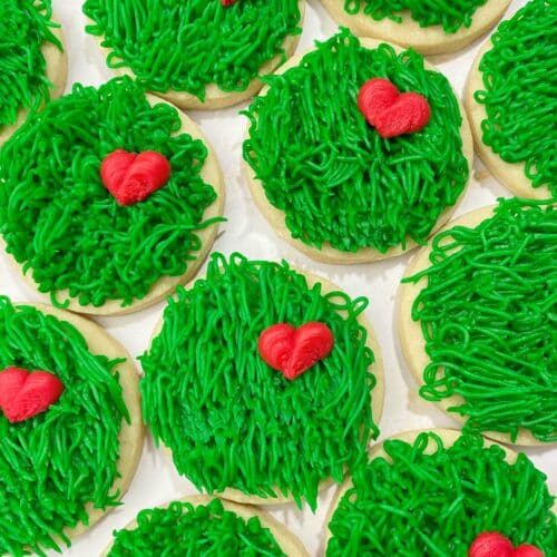 green grinch sugar cookies with buttercream hearts