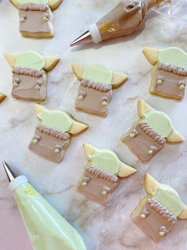 piping baby yoda cookies with buttercream frosting