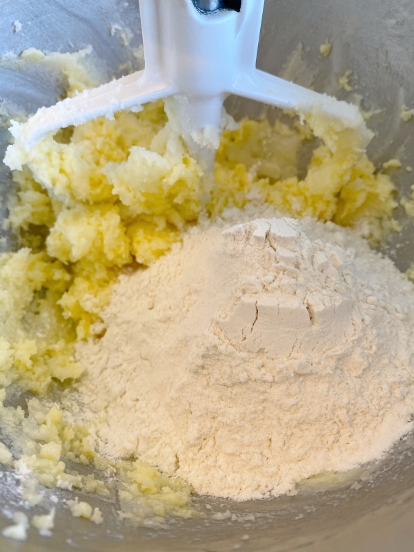 mixing flour into almond sugar cookies