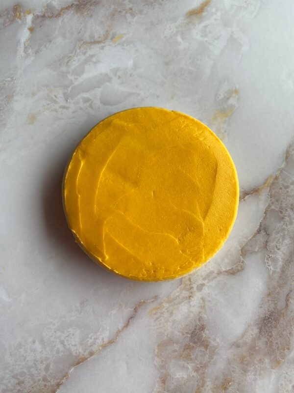 smoothed yellow frosting on cookie