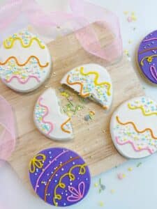 Sprinkle filled Easter egg cookies with buttercream frosting and Foliay sprinkles